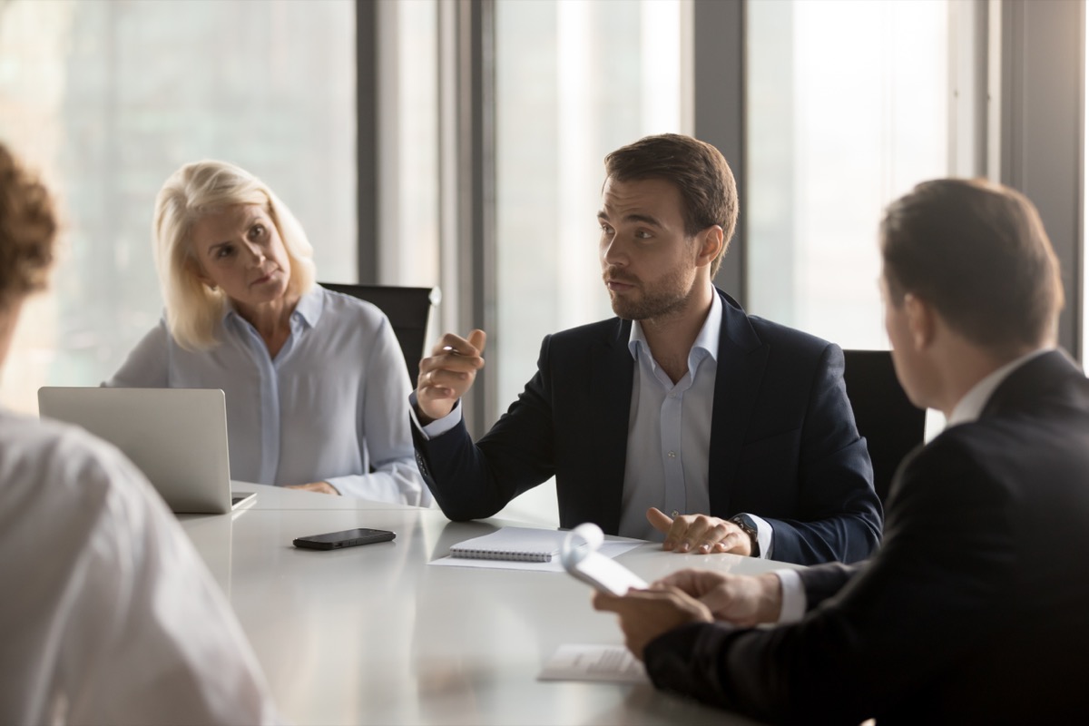 Corporate board meeting room with ESG governance documents